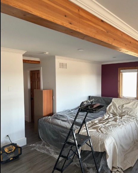 Bedroom before — white with maroon accent wall
