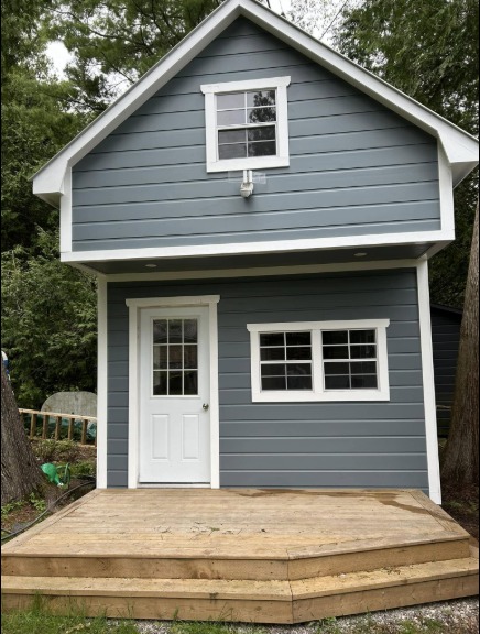 Cabin after — grey-blue with white trim
