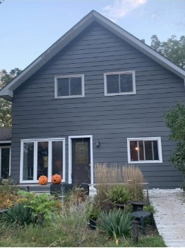 House siding after — fresh dark grey paint